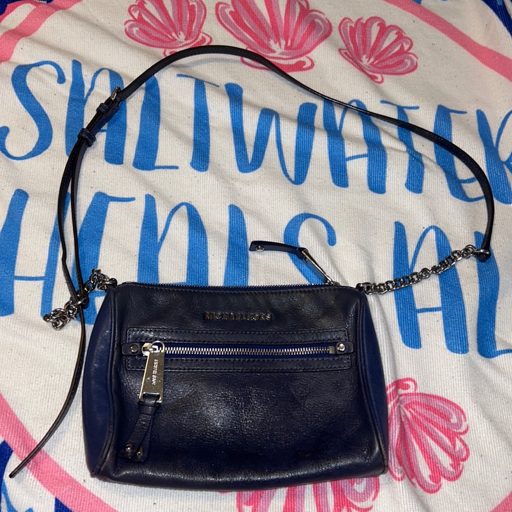Michael Kors purse navy blue with damages leather material.